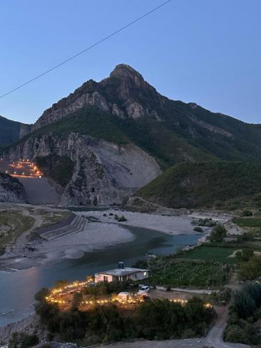 a view of a river with a mountain in the background at Breeze of the Drin Guesthouse Camping in Vau i Dejës