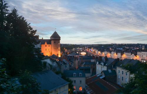 a view of a city at night with a castle at L'Envolée, Proche Gare SNCF, Confort, Netflix in Laval