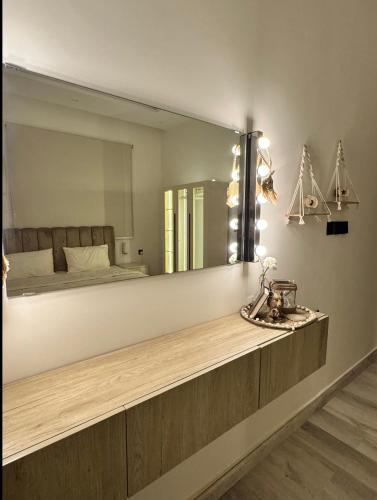 a bathroom with a large mirror and a sink at Modern Apartment in Jeddah