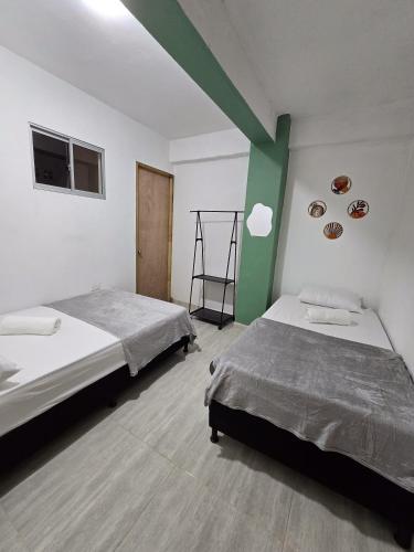 a bedroom with two beds and an apple sign on the wall at Apartamento en jardin in Jardin