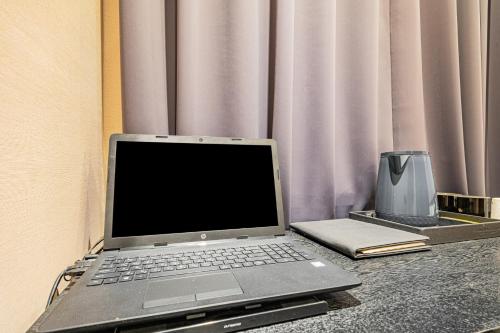 a laptop computer sitting on top of a table at Pyeongtaek Stay Tourist Hotel in Pyeongtaek