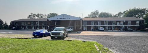 a large building with a truck parked in front of it at Economy Inn in Kankakee