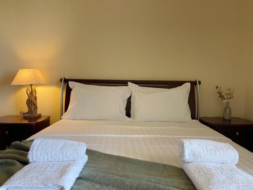 a bedroom with a bed with two towels on it at Villa Elpida in Kriopigi