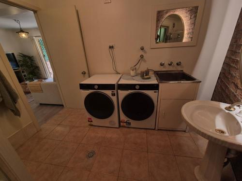 a bathroom with a stove and a sink in it at Emerald Escape in Emerald Beach