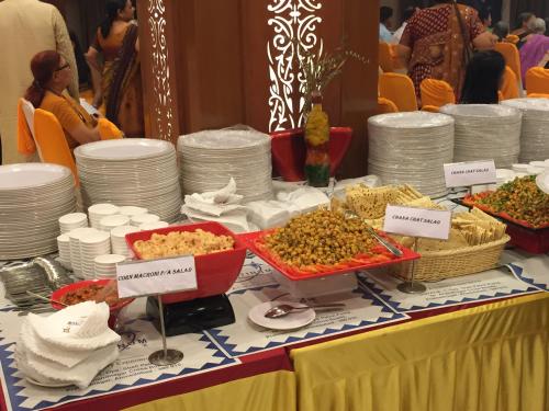 a buffet of food on a table with plates and dishes at Hotel Platinum Residency in Ahmedabad
