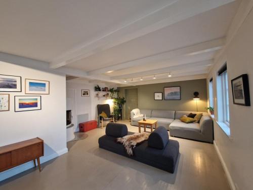 a living room with two couches and a couch at Charming house by the sea in Svenevik