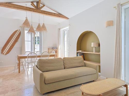 a living room with a couch and a table at Feet in the water, 100 m from the city center in La Tranche-sur-Mer
