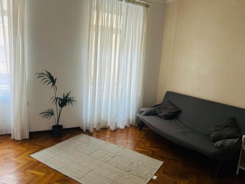 a living room with a couch and a potted plant at Casa Vacanze Angelina in Trieste