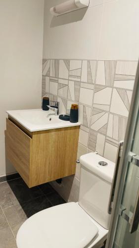 a bathroom with a toilet and a sink at Vénus #Love room# in Capesterre-Belle-Eau