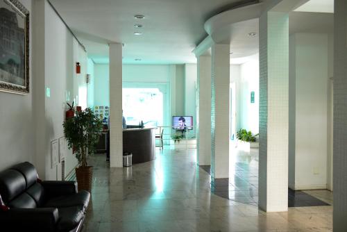 a lobby with a couch and a table in a room at Palace Hotel in Araguari