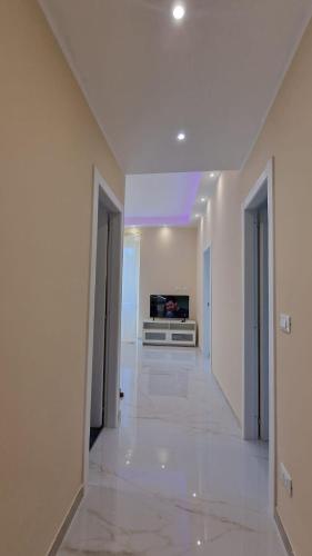 a white hallway with a television in a room at emguesthouse in Camogli