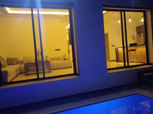 a living room with a couch and a mirror at Villa Chez Badre with Pool High Standing in Sidi Rahal