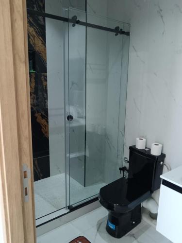 a bathroom with a glass shower with a toilet at Villa Chez Badre with Pool High Standing in Sidi Rahal