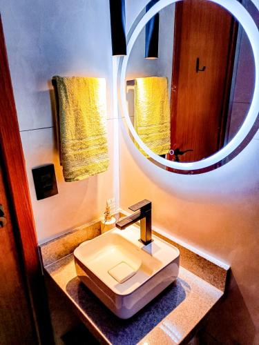 a bathroom with a sink and a mirror at Loft 1178 in Santa Teresa