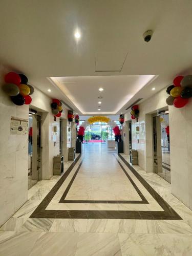 a hallway of a building with a hall with balloons at Cent Al Azizia Hotel Makkah in Makkah