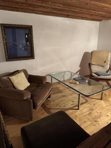 a living room with a couch and a glass table at Fürstentor Greding in Greding