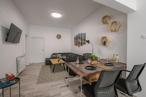 a living room with a table and a couch at Grand Luxury Condo by NDK and National Stadium with Free Security Parking in Sofia
