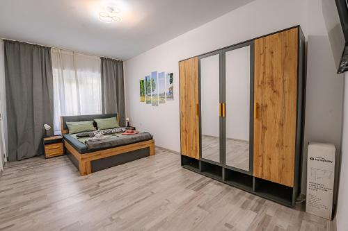 a room with a bed and a large glass closet at Grand Luxury Condo by NDK and National Stadium with Free Security Parking in Sofia