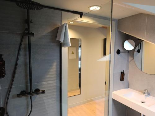 a shower with a glass door in a bathroom at U-Hotel Aduana Ribadeo in Ribadeo