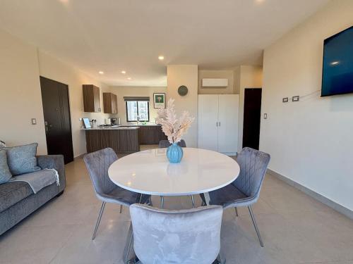 a living room with a white table and chairs at Vinedos del Mar 2BR 2BA with pool in Ensenada