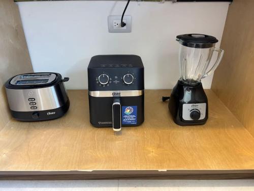 a blender and a toaster sitting on a shelf at Vinedos del Mar 2BR 2BA with pool in Ensenada