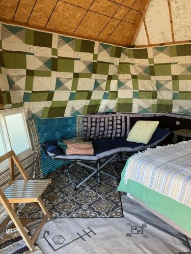 a room with a bed and a couch in a yurt at The Dome at Tribal Camp in Joshua Tree