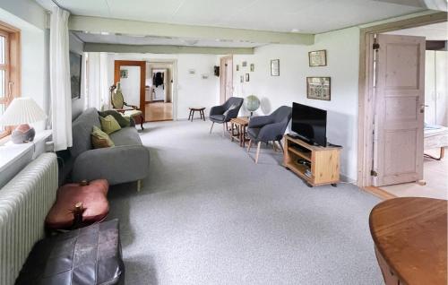 a living room with a couch and a tv at 2 Bedroom Amazing Home In Samsø in Toftebjerg