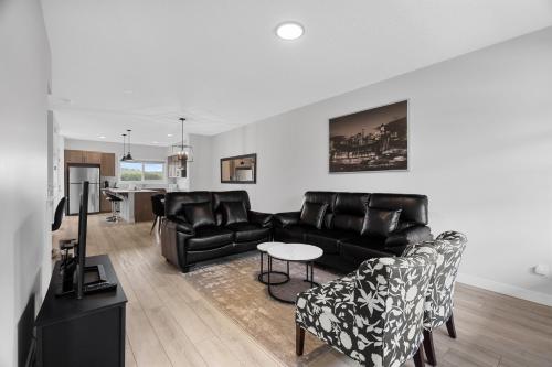 a living room with a couch and a table at Spacious 3-Bedroom Vacation Home in Calgary with Free Parking in Calgary