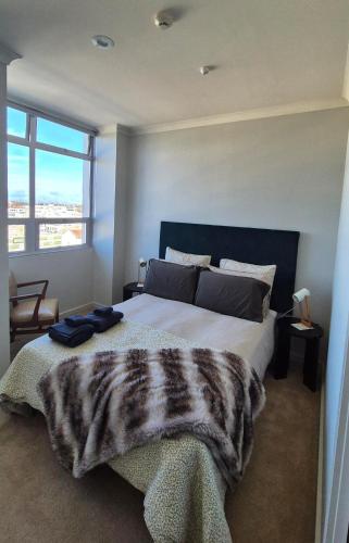 a bedroom with a large bed and a window at 2 Bed Apartment-Panoramic Views in Napier