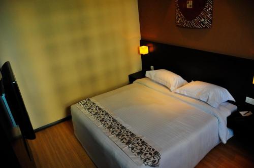Tat Place Hotelにあるベッド
