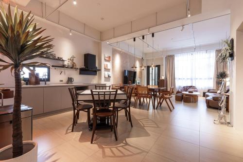 Una cocina y una sala de estar con mesa y sillas. en Lunar Haven, en Magong