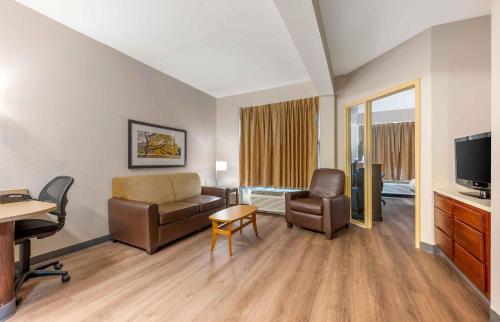 a living room with a couch and chair and a television at Extended Stay America Suites - Indianapolis - Airport - W Southern Ave in Indianapolis