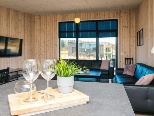 a table with wine glasses and a potted plant at 5 star holiday home in Grenaa in Brøndstrup