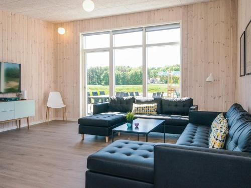 a living room with a couch and a table at 5 star holiday home in Grenaa in Brøndstrup