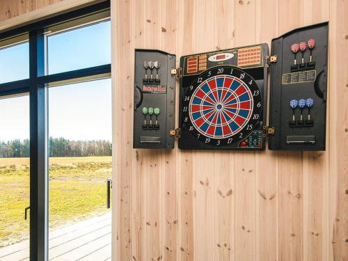 a dart board on the side of a wooden wall at 5 star holiday home in Grenaa in Brøndstrup