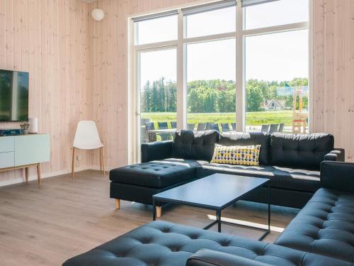 a living room with a couch and a table at 5 star holiday home in Grenaa in Brøndstrup