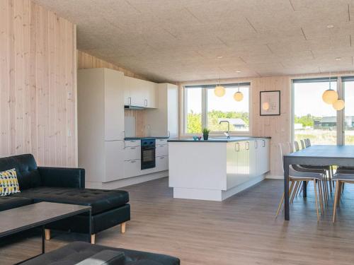 a kitchen and a living room with a table at 5 star holiday home in Grenaa in Brøndstrup