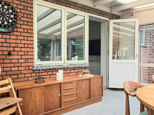 a window on a brick wall with a mirror on it at 6 person holiday home in Ansager in Ansager