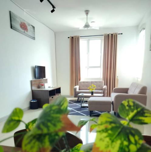a living room with a couch and a chair at Inap Tanjung Homestay in Kuala Terengganu