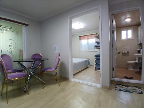 a room with a table and chairs and a bedroom at Gangane Anjirang in Daegu