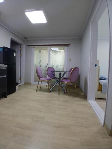 a dining room with purple chairs and a table at Gangane Anjirang in Daegu