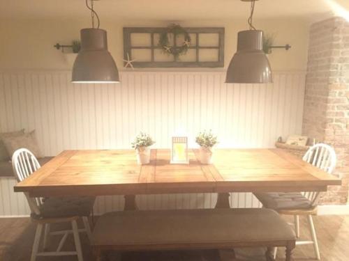 a dining room table with two chairs and two lights at Ocean Manor 1100 Inn in Ocean City