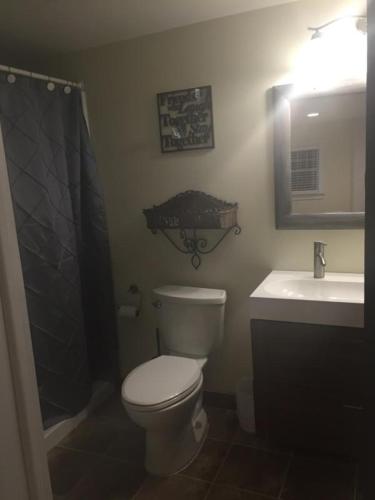 a bathroom with a toilet and a sink at Ocean Manor 1100 Inn in Ocean City