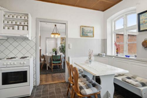 a kitchen with a table and a dining room at 580 M2 Countryside Idyll With Activity Room in Haderslev