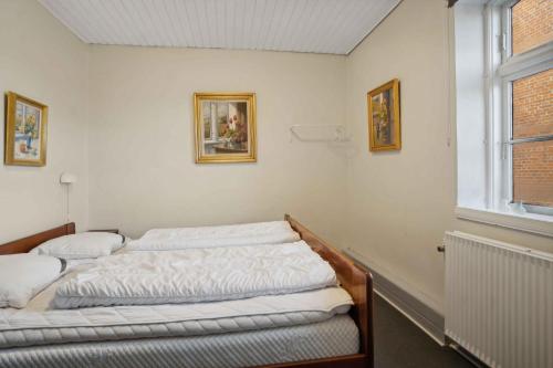 two beds in a room with a window at 580 M2 Countryside Idyll With Activity Room in Haderslev