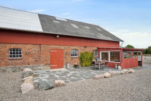 a red brick building with a patio in front of it at 580 M2 Countryside Idyll With Activity Room in Haderslev