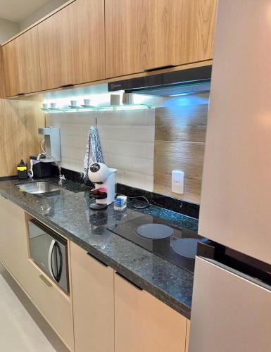 a kitchen with a sink and a counter top at Apto novo perto da UFF e Plaza in Niterói