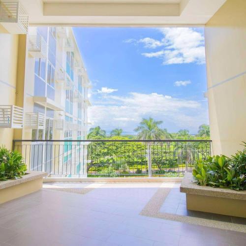 a balcony with a view of a building at Berkeley Breeze Staycation in Silang