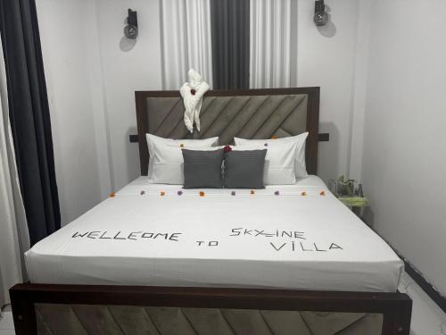 a bed with a wooden headboard and white pillows at Skyline & bitcoin coffee lodge in Kalutara