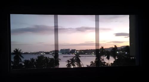 a window with a view of the water at Apartamento con vista al mar in Pampatar